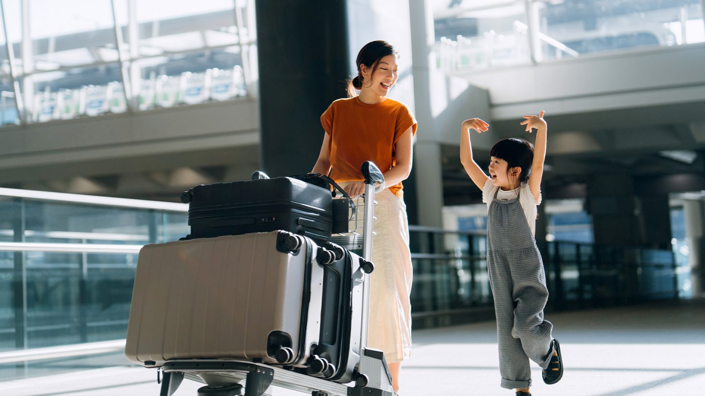 Woman and child with luggage at the airport.